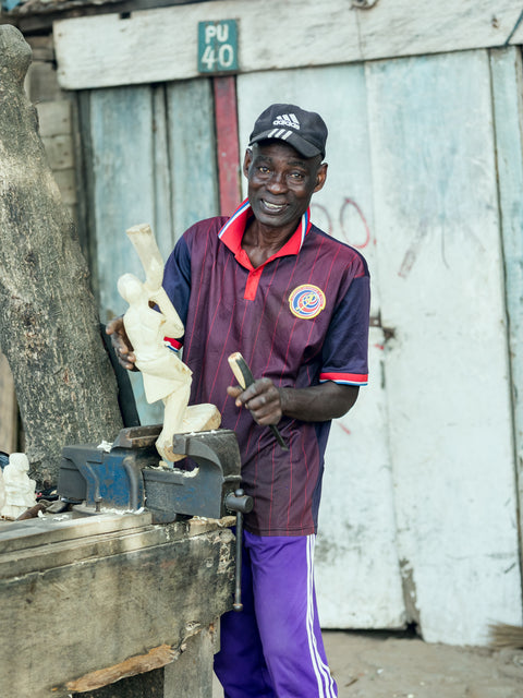 Artisan working on his sculpture in Ghana, West Africa