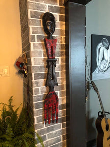 african home decor fork with a man's face on the handle of the fork displayed on the wall of livingroom in a home
