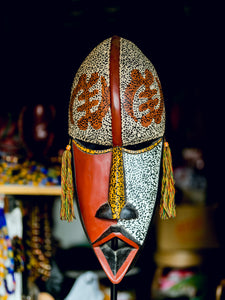 african mask with gold flecks, adinkra symbols and gold tassles