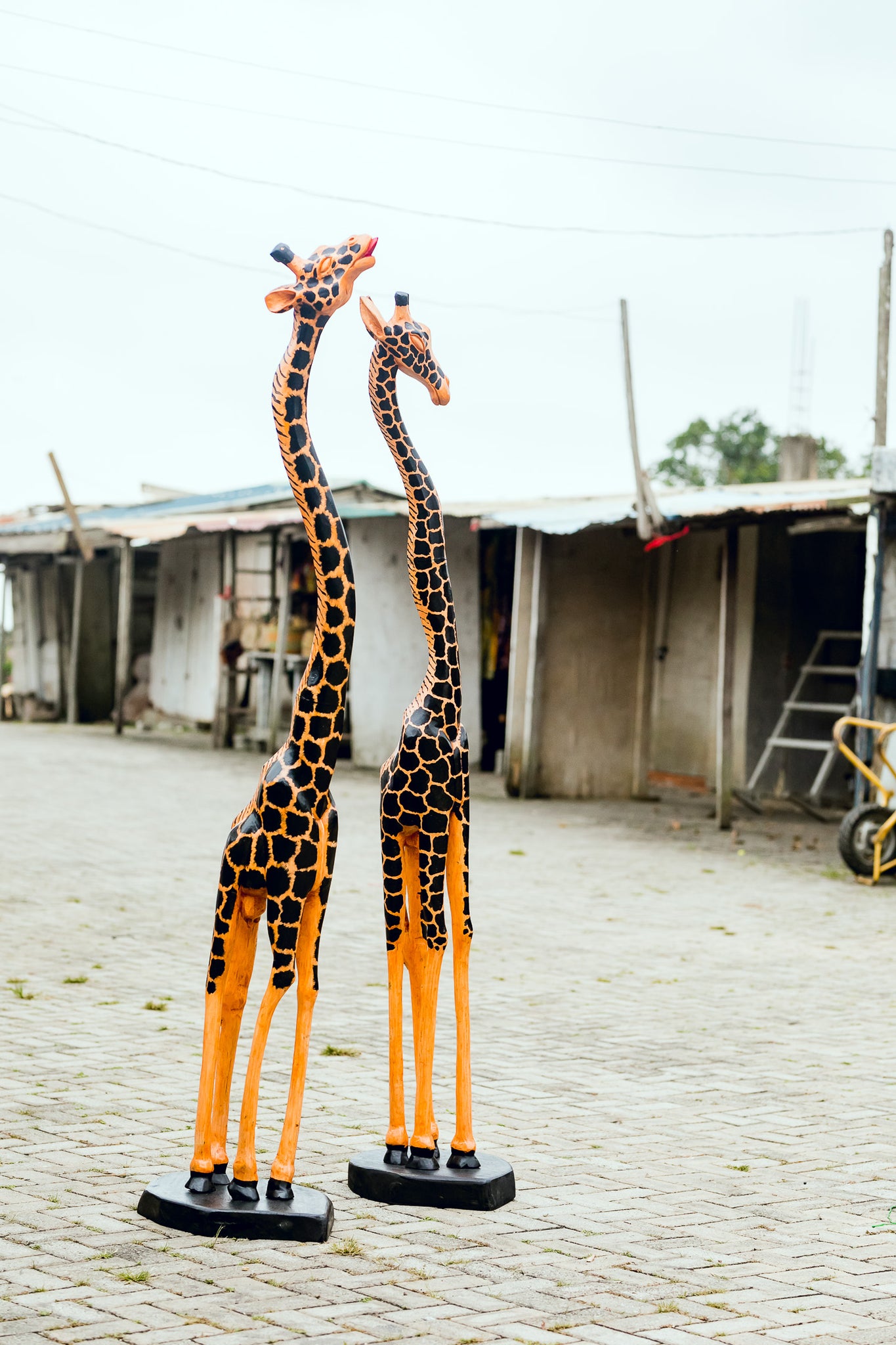 African Wood Sculpture-Gigantic Giraffe, hand-carved of white wood, Ghana, West Africa Smaller of the Pair (on right side in photo) 240 cm X 49 cm